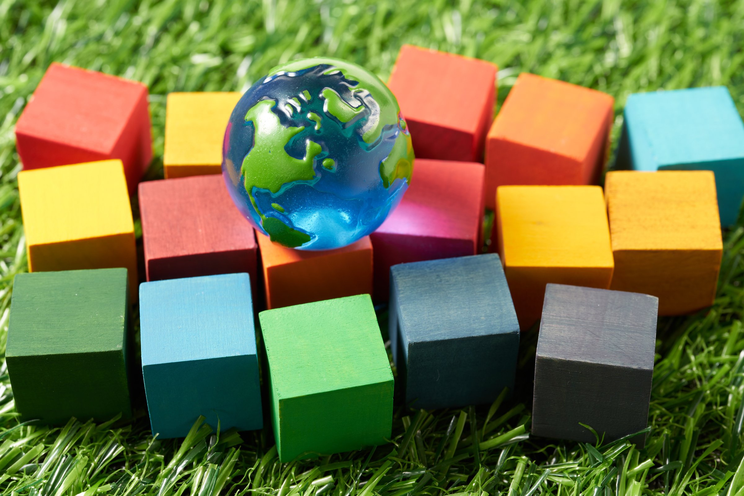 globe and a wooden cube stamped with the letters SDGs.